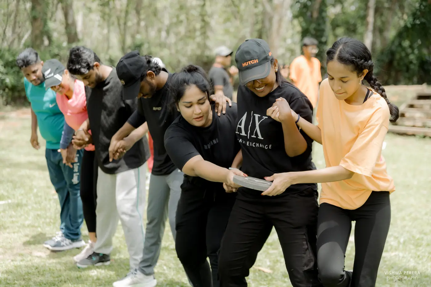Participants coordinating closely during an experiential team challenge